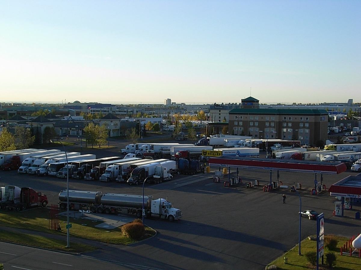 Trucks parked at a travel centre's fuel islands in early morning