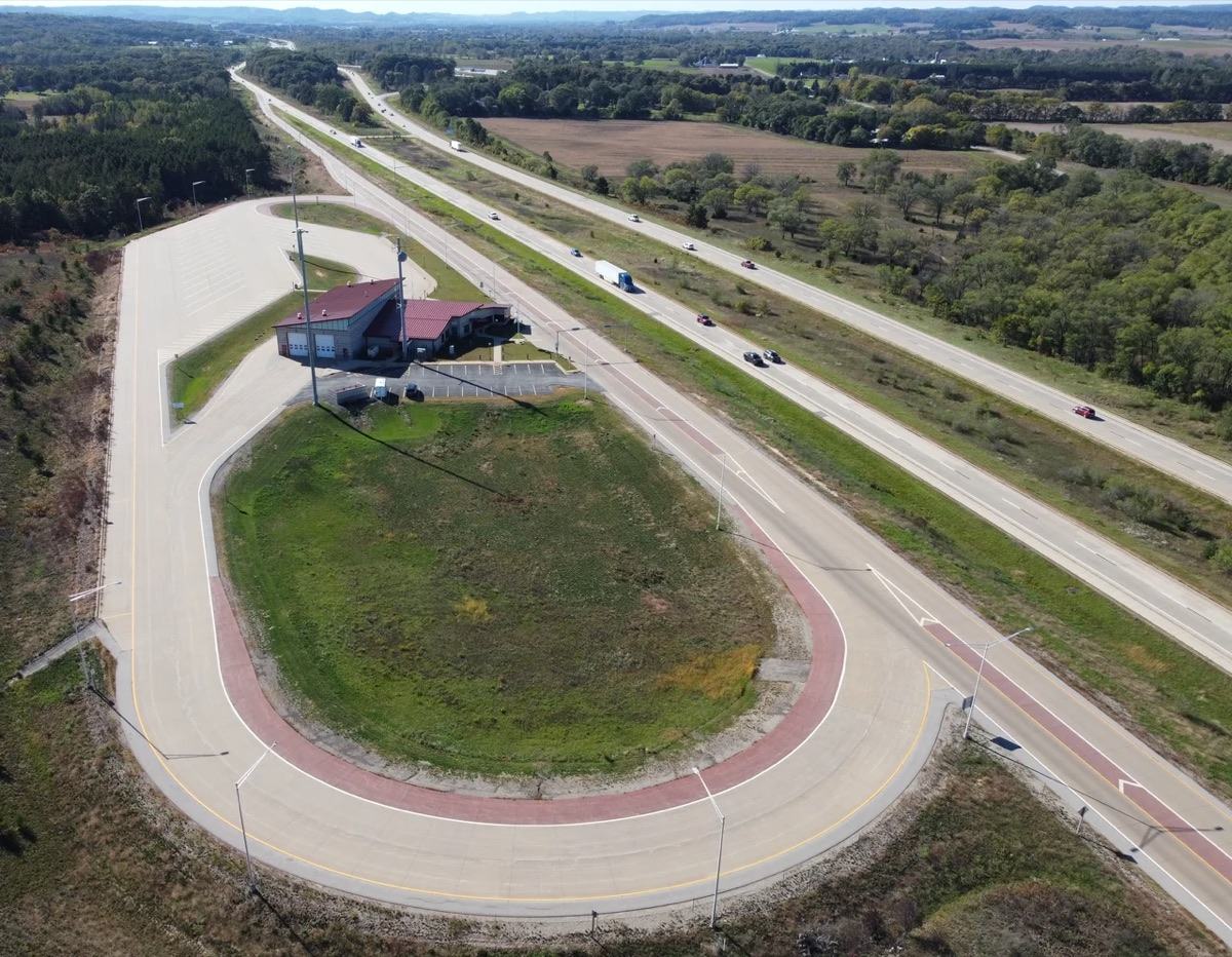 Aerial view of an interstate weigh station with its ramp and scale house